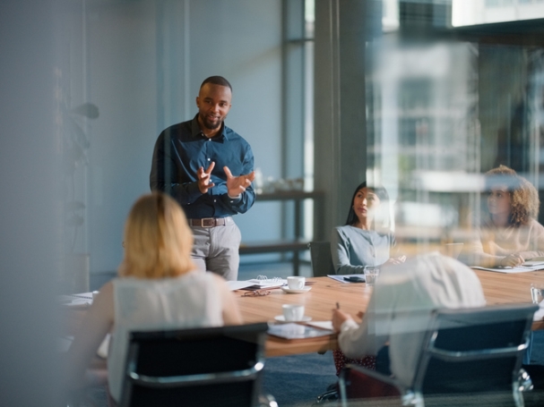 Businessman, meeting and discussion with office, boardroom and collaboration or workshop. Leader, training and presentation for mentor, coaching and strategy for teamwork and planning with startup